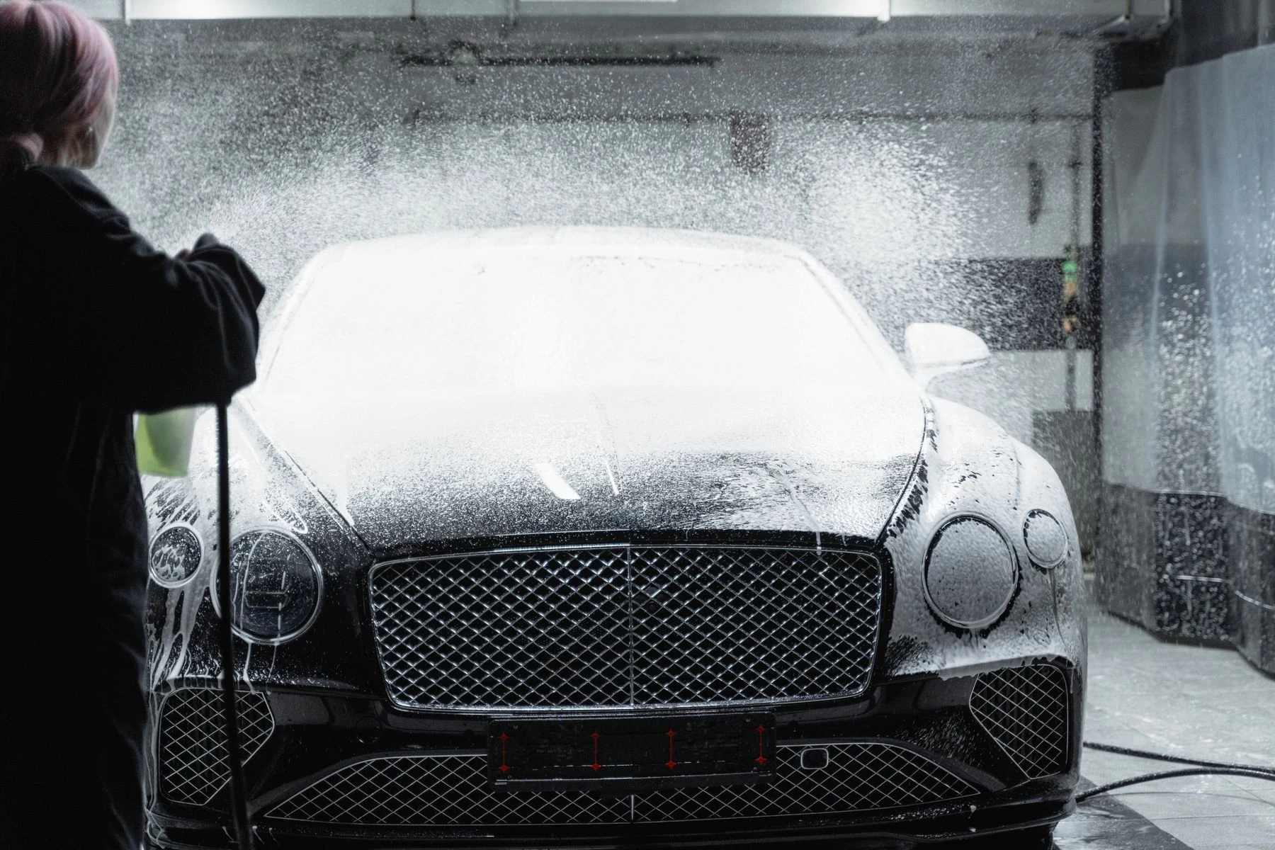 Illustrative stock photograph of a black car being washed